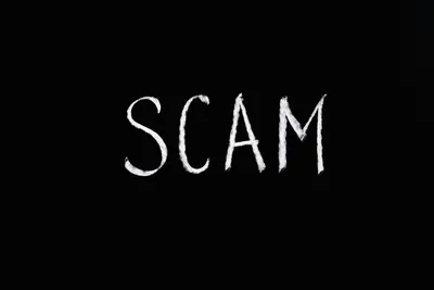 Scam Lettering Text on Black Background · Free Stock Photo